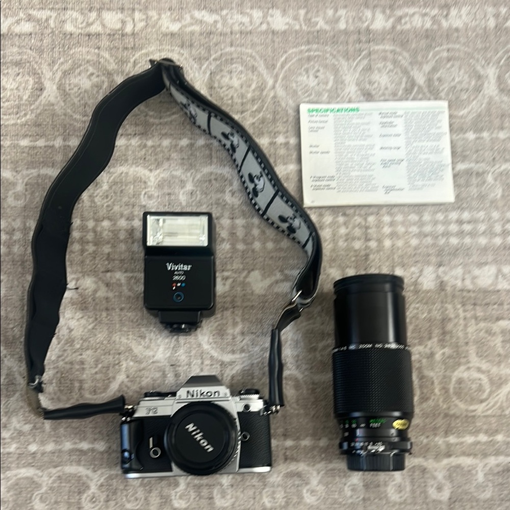 Nikon Black & Silver Camera with Vivitar Flash